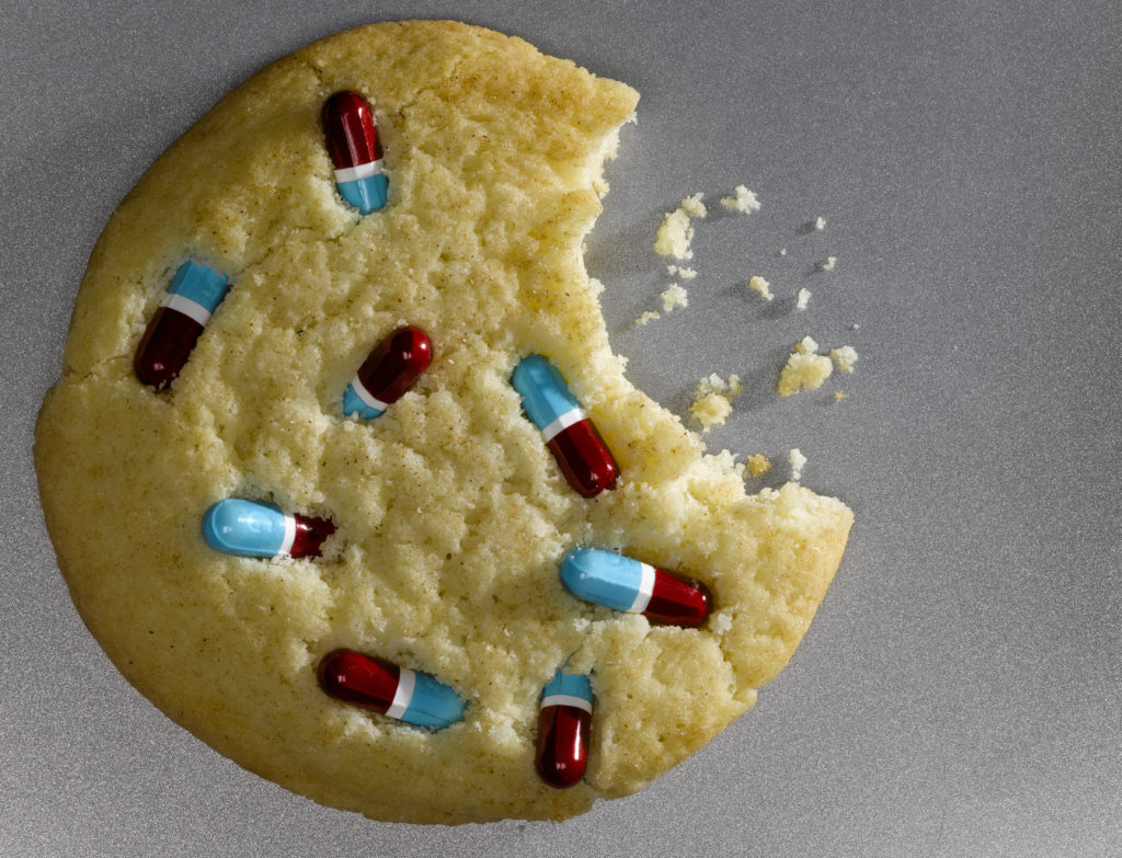 Bitten cookie decorated with pills